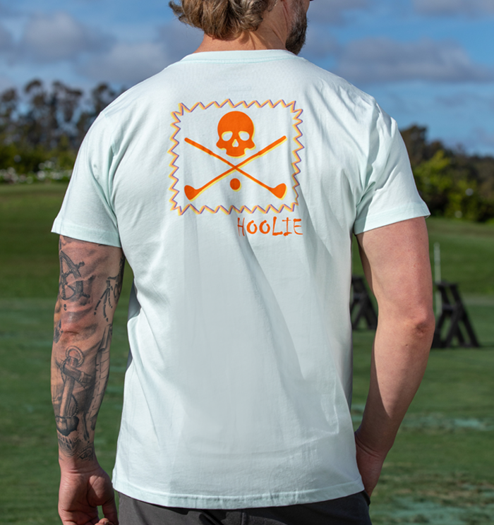 Men's Golf T shirt in Iceberg with orange and yellow vintage X Bones graphic and multicolor zig-zag box.