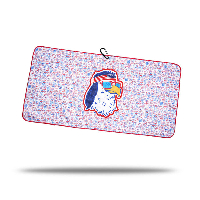 The 'Merica - Towel is a rectangular microfiber gym towel with red trim, blue and red pattern, a central cartoon eagle head wearing "AMERICA" sunglasses, 2-sided print, and a black clip on one corner.
