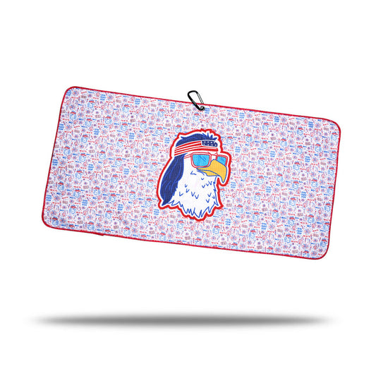 The 'Merica - Towel is a rectangular microfiber gym towel with red trim, blue and red pattern, a central cartoon eagle head wearing "AMERICA" sunglasses, 2-sided print, and a black clip on one corner.