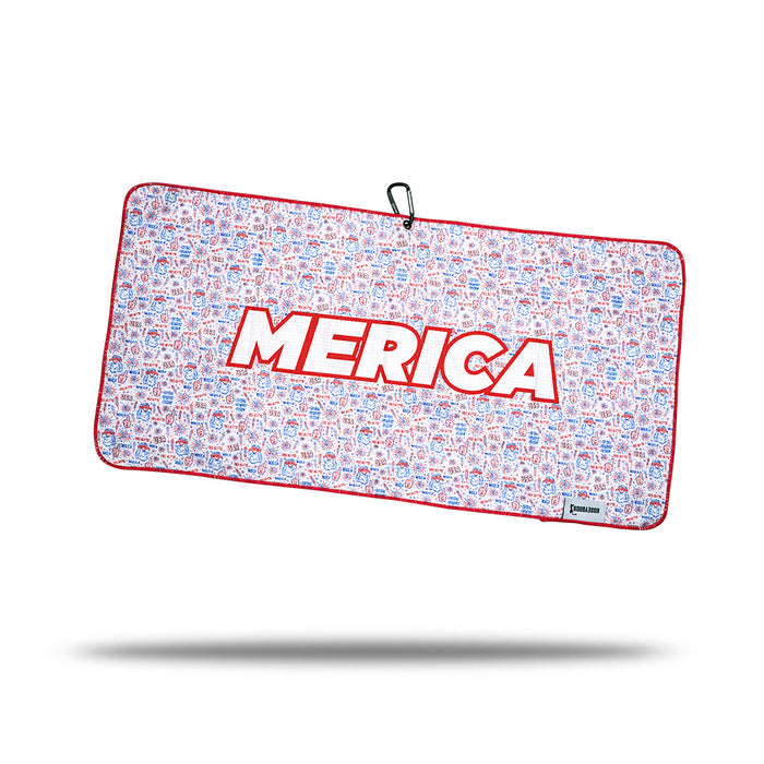 The 'Merica - Towel is rectangular, printed on both sides with red borders and “MERICA” in bold white letters over doodle-style patriotic icons, plus a black carabiner at the top for easy attachment.